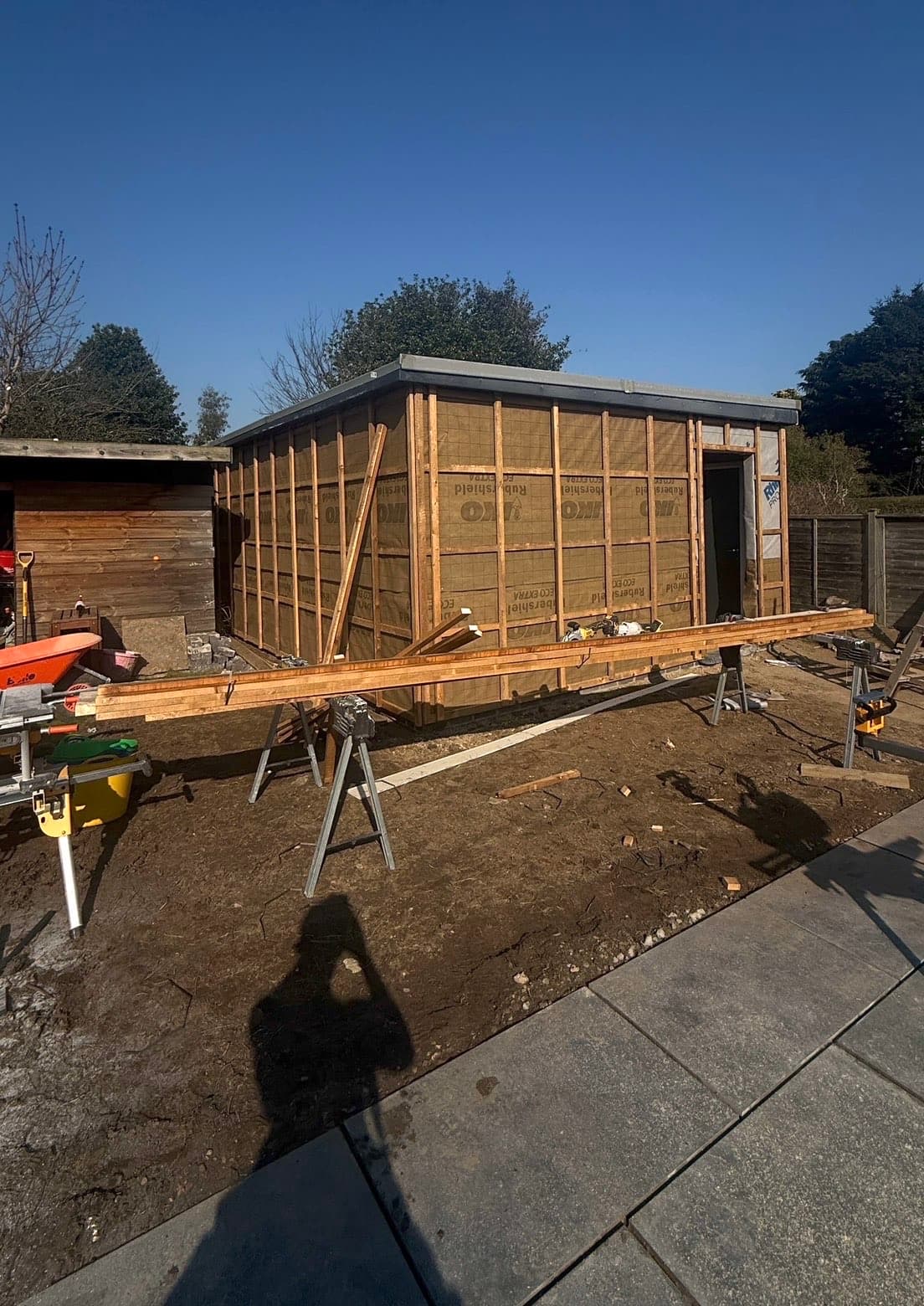 The same garden room at an earlier build stage, timber frame wrapped in a breathable membrane before external cladding